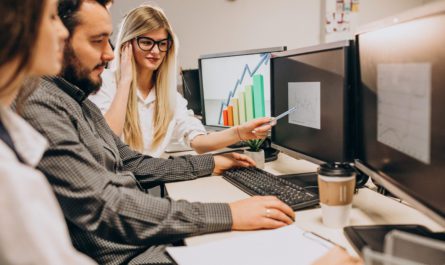 Workers at an IT company working on a computer